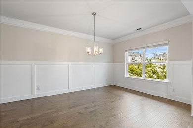 Unfurnished dining area featuring a decorative wal