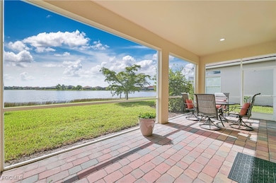 View of patio with a water view and outdoor dining area
