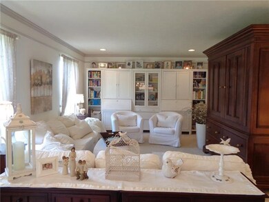 Formal Living Room with crown moulding recessed li