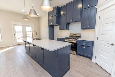 Kitchen featuring a center island with sink, decor