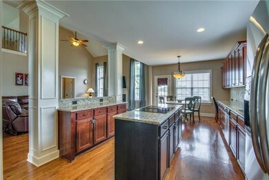 The gathering place for the whole family, the Kitchen offers many distinct features such as a built-in island with cook top, granite counters, tile backsplash, and GE Stainless   appliances.