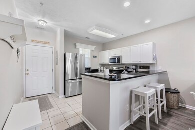 Kitchen with a kitchen bar, visible vents, applian