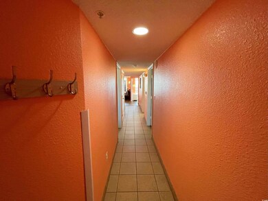 Corridor featuring light tile patterned floors