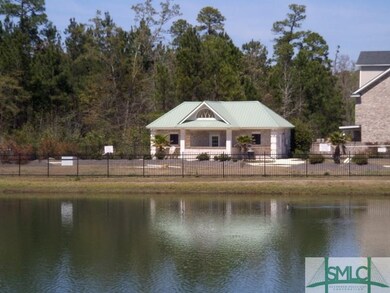 view of pool house from across lake