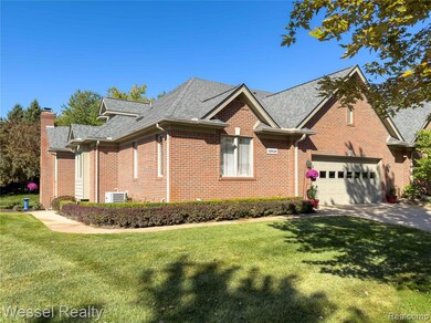 Ranch-style house featuring a front yard, brick siding, a shingled roof, and a chimney