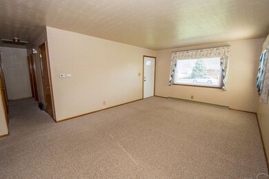 Hardwood floors underneath carpet.  Great living s