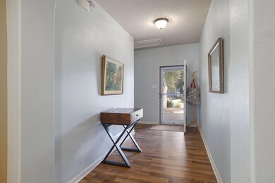 Doorway to outside featuring dark wood-style floo