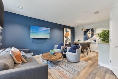 Living room featuring wood finished floors, reces