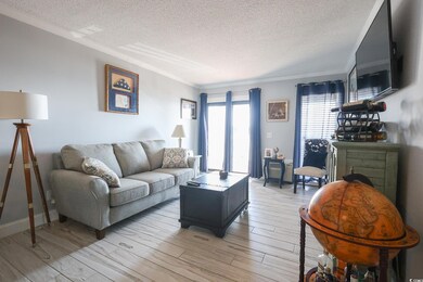 Living area featuring light wood-style floors, a t