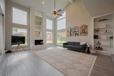 High ceiling and lots of windows decorate the livi