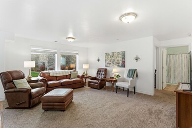 Living area with light colored carpet and baseboards