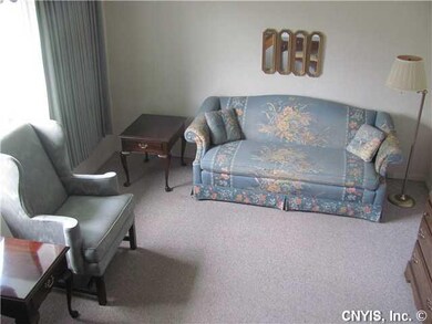 Living Room. The living room has neutral carpeting