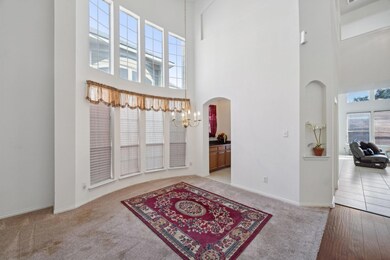 Foyer with light wood-type flooring, a chandelier,