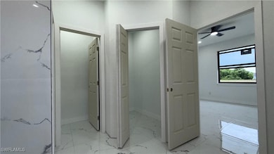 Bathroom featuring marble finish flooring and a ce
