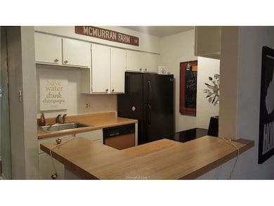 Kitchen with sink, stainless steel dishwasher, whi
