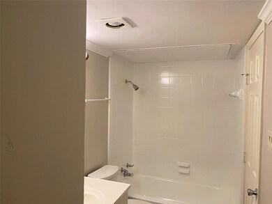 Full bathroom featuring vanity, toilet, and tiled 