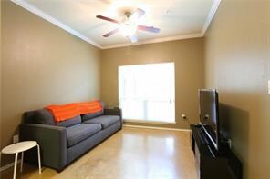Living area with crown molding, ceiling fan, and 