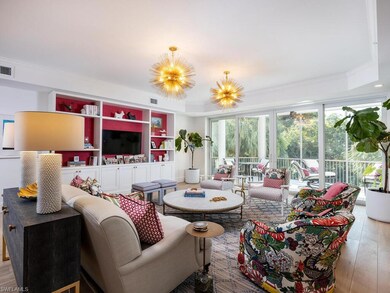 Living area featuring hardwood / wood-style floors, a chandelier, and ornamental molding