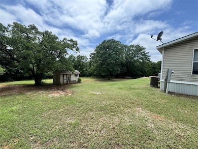 View of grassy yard featuring central AC