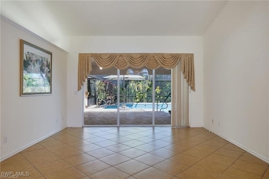 Empty room with light tile patterned flooring and