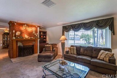Floor to ceiling brick fireplace with wood mantle 