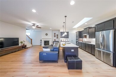 Kitchen with a sink, a glass covered fireplace, op