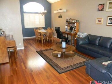 The living room is spacious and has vaulted ceilin