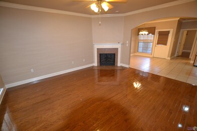 Wood floors with electric fireplace in a central location to kitchen and both bedrooms.