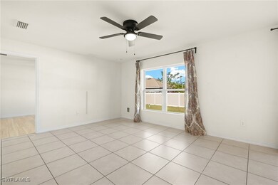 Empty room with ceiling fan, baseboards, and light