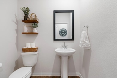 Half bathroom with wood finished floors and toilet