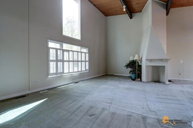 Living room w/soaring windows