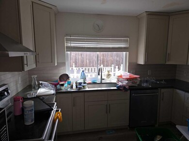 Kitchen featuring dark countertops, gray cabinets,