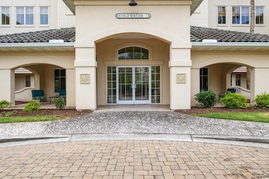 Doorway to property with french doors, a tile roof, and stucco siding