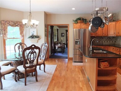 Kitchen has granite counters and tile backsplash.