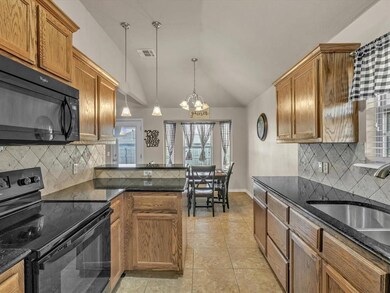 Kitchen featuring black appliances, backsplash, va