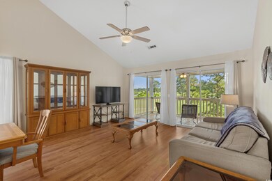 Living room with high vaulted ceiling, ceiling fan