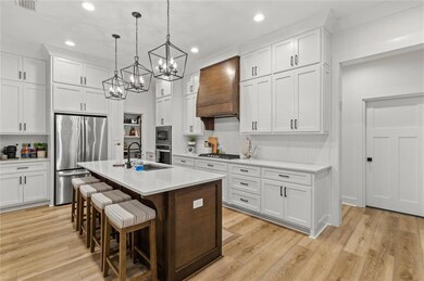 Kitchen featuring stainless steel appliances, a si