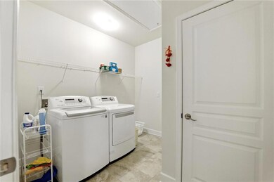Clothes washing area featuring washer and clothes 