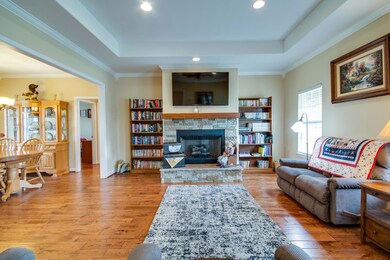 GREAT VIEW OF THE NEWER STACK STONED FIREPLACE! TREY CEILING & CEILING FAN!