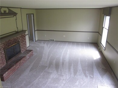 Living room view from the staircase, front door to
