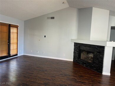 Unfurnished living room with lofted ceiling, dark