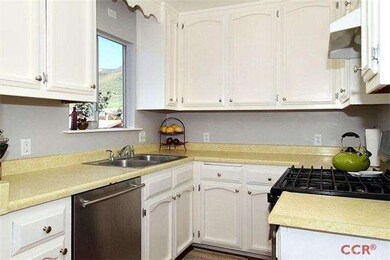 Small but efficient kitchen has maple floors and s