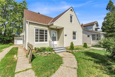 View of front of house featuring a front yard and a garage