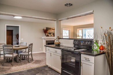 The kitchen has a breakfast bar to the living room