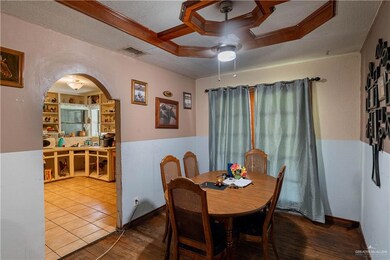Dining space with ceiling fan, coffered ceiling, a textured ceiling, and hardwood / wood-style floors