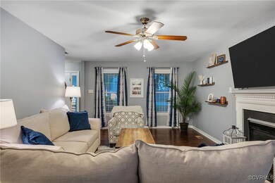 Living area featuring ceiling fan, wood finished f