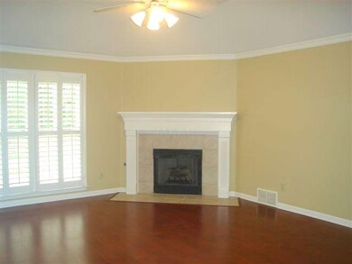 Family Room w/gleaming hardwood floors, plantation