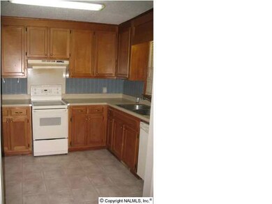 Kitchen features corian countertops and new vinyl flooring. All appliances including the refrigerator remain!