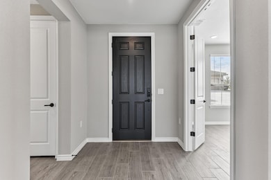 Foyer featuring wood tiled floors and baseboards