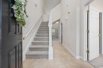 Stairs with baseboards and a high ceiling